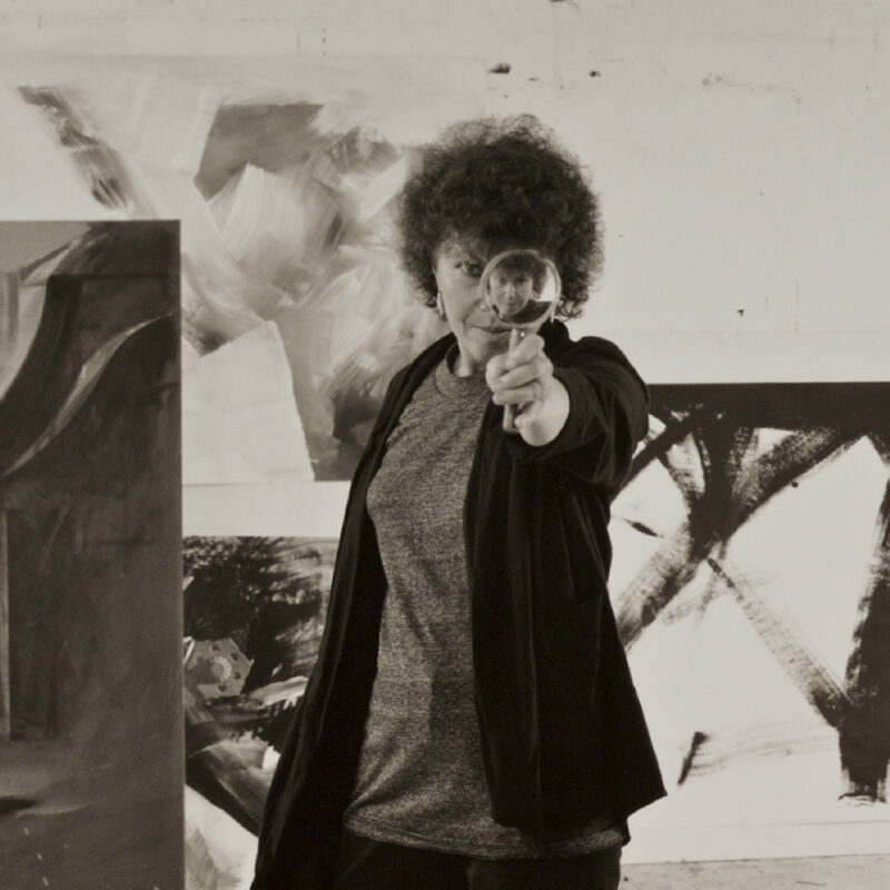 M. Lee Fatherree, Jay DeFeo in her Oakland studio with reducing glass, 1986